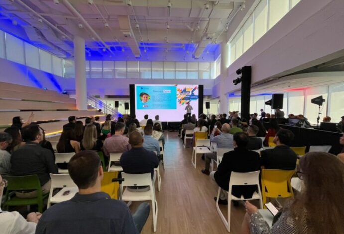 Imagem de uma palestra com diversas pessoas